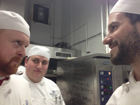 Redhead Hank and Lumberjack Sean lock eyes with the audience of Josh in the background.