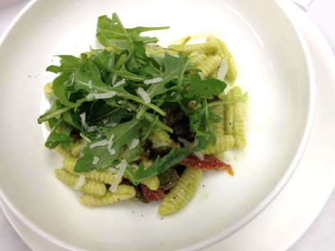 Cavatelli topped with arugula.